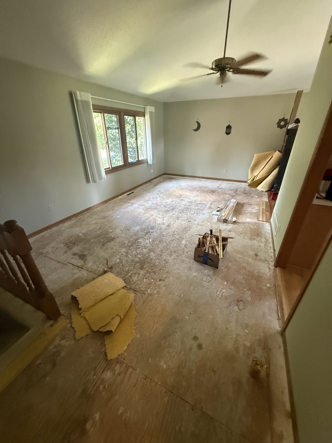 Living room down to bare subfloor, ready for new flooring